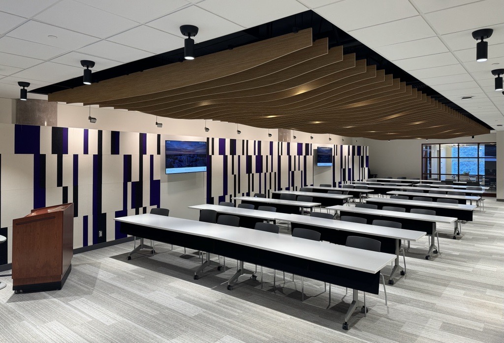 A podium, tables and screen in the staff and student learning centre