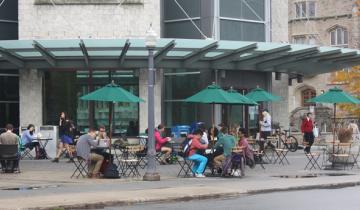 Library Square with tables and chairs outside Stauffer Library. 