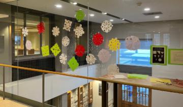 snowflake crafts displayed on a window in the engineering and science library