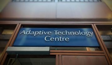 A sign above a door that reads Adaptive Technology Centre