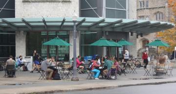 Library Square with tables and chairs outside Stauffer Library. 