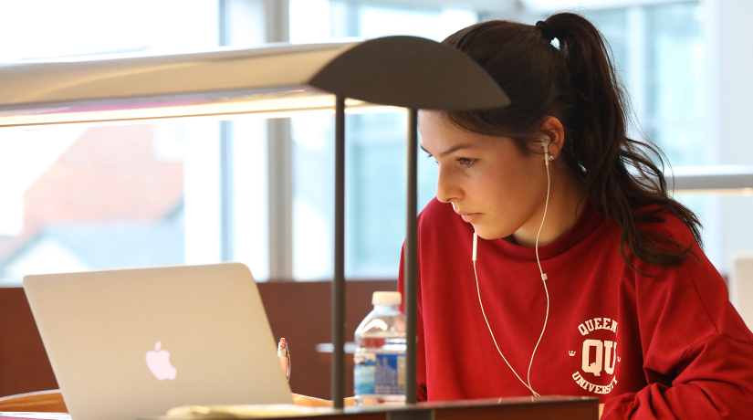 Student sitting a desk working on her laptop