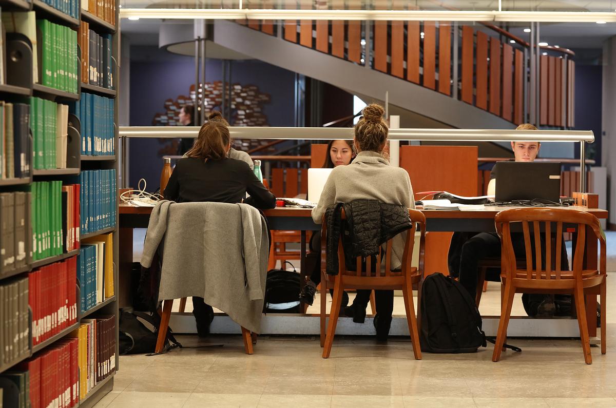 students working on laptops in the library 