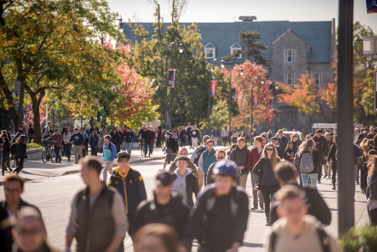 Students walking on campus in the fall