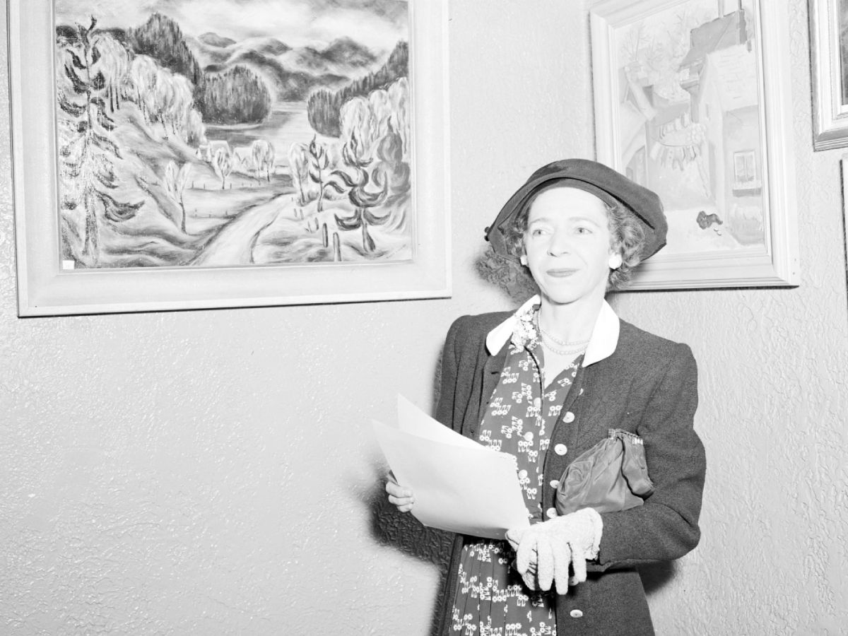 Item is a photo of Art Exhibition, Photo of Andre Bieler and others at Art exhibition (likely on campus)