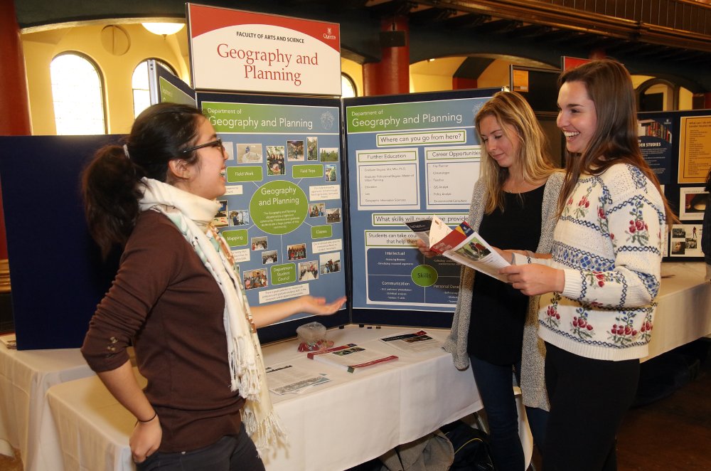 Students talking in front of a poster