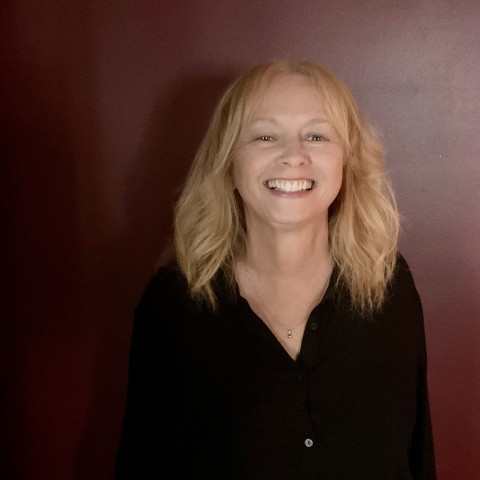 Image of person with blonde hair and black shirt