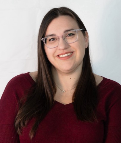 Photo of woman with brown hair and glasses.