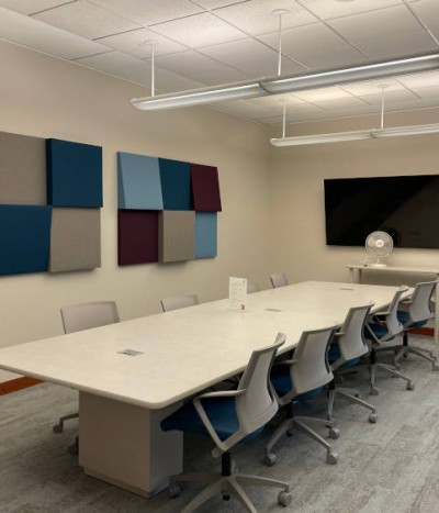 Interior view of conference table and display screen in the Helen Howard Graduate Student reading room