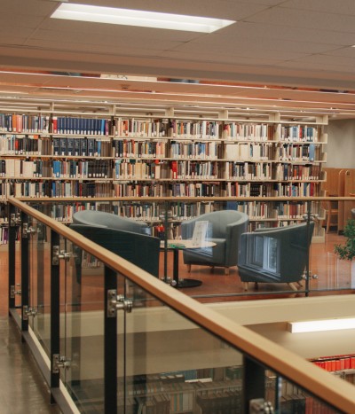 Chairs and book stacks in the Law Library's lounge.