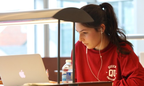 Student sitting a desk working on her laptop