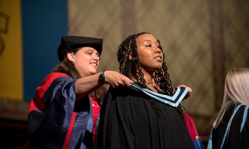 Graduate receiving hood as part of the convocation ceremony