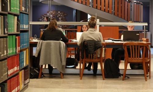 students working on laptops in the library