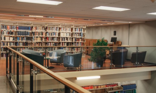 Chairs and book stacks in the Law Library's lounge.