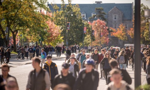 Students walking on campus in the fall