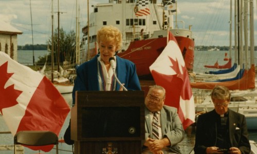 photograph taken during the plaque unveiling ceremony commemorating Kingston Dry Docks. Flora MacDonald is identified.