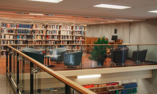 Chairs and book stacks in the Law Library's lounge.