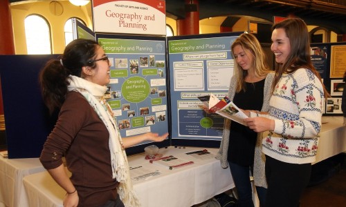 Students talking in front of a poster